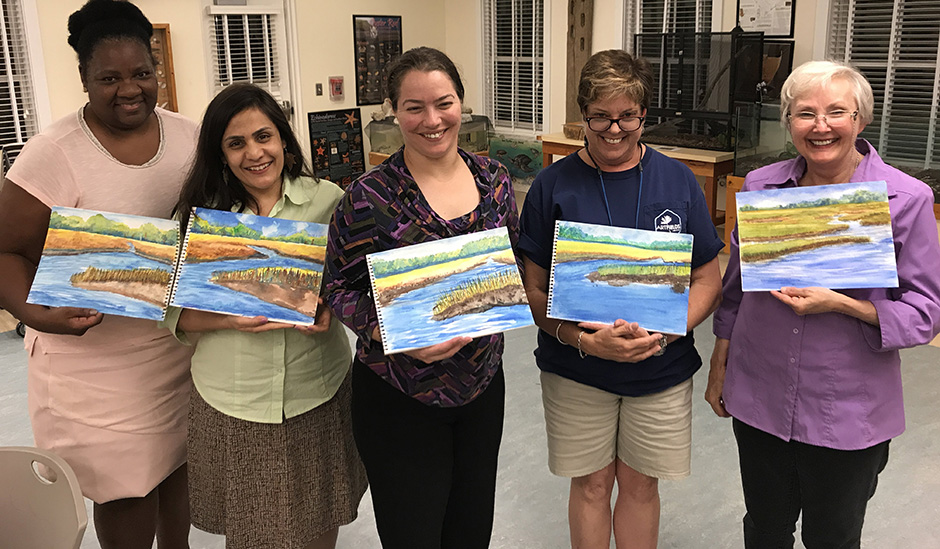 Participants in the Paint and Pluff Mud program display their artwork.